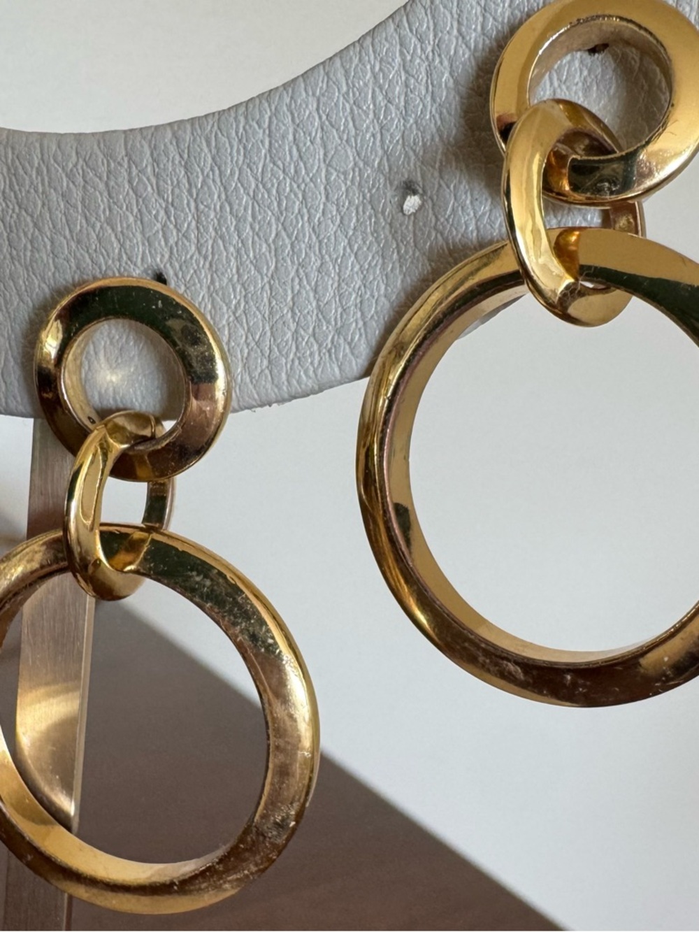 Jenny Bird high polish gold earrings with three interlocking hoops.